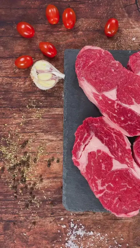 Raw ribeye steaks up close: marbling