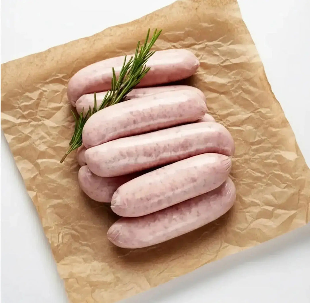 Six raw British pork sausages on butcher paper for creamy sausage pasta – buy pork sausages online UK