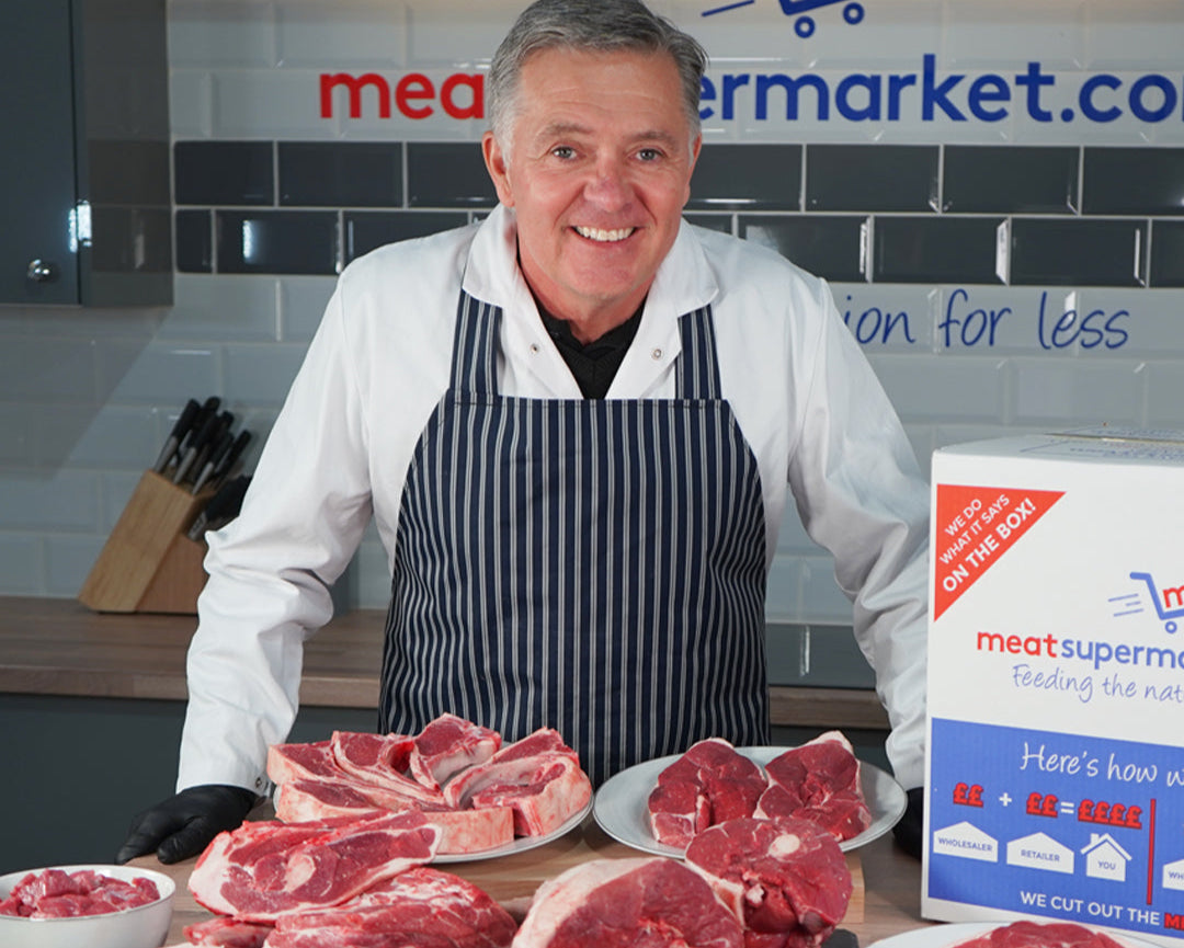 Our butcher at the meatsupermarket.com counter with fresh lamb cuts and a delivery box