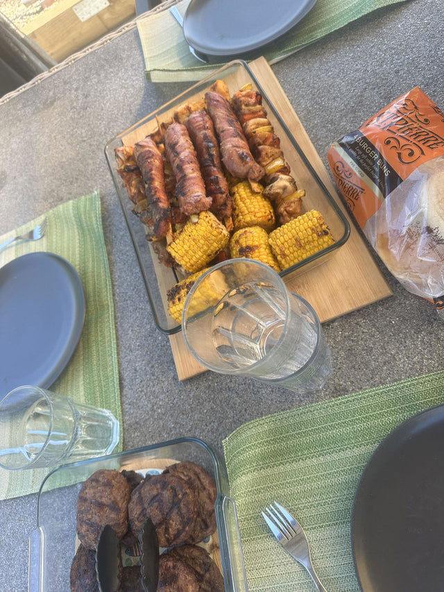 Customer review photo: scorpion marinated chicken kebabs and corn on a garden table