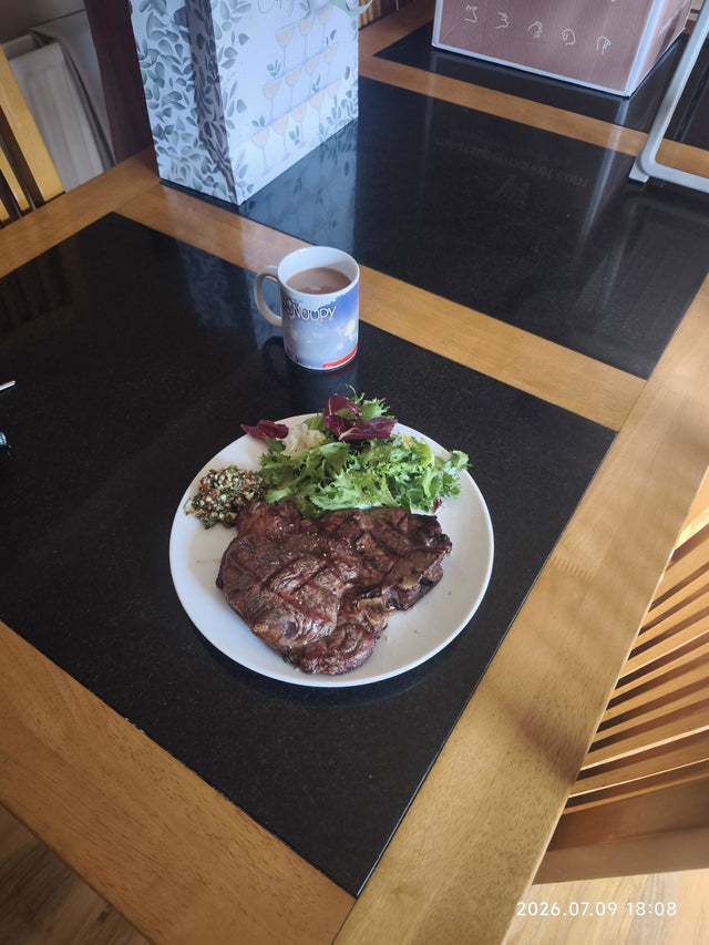 Cooked T-bone steak served with salad – customer photo of a meatsupermarket.com steak dinner