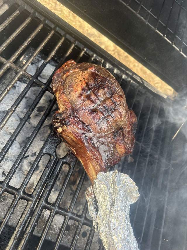Tomahawk steak cooking on a barbecue – customer photo of a meatsupermarket.com tomahawk