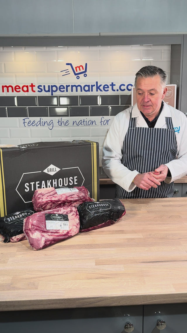 Our butcher unpacking Gaucho beef from a Steakhouse box at the counter