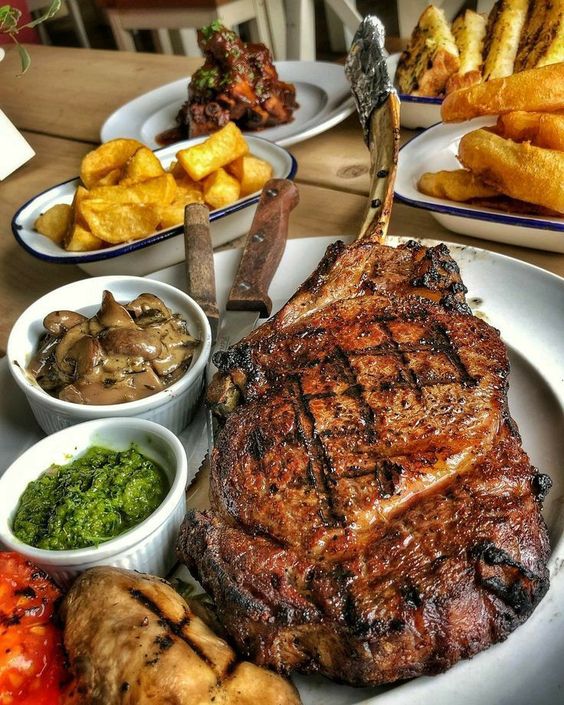 Chargrilled tomahawk steak served with chips, mushrooms and chimichurri – tomahawk steak serving idea