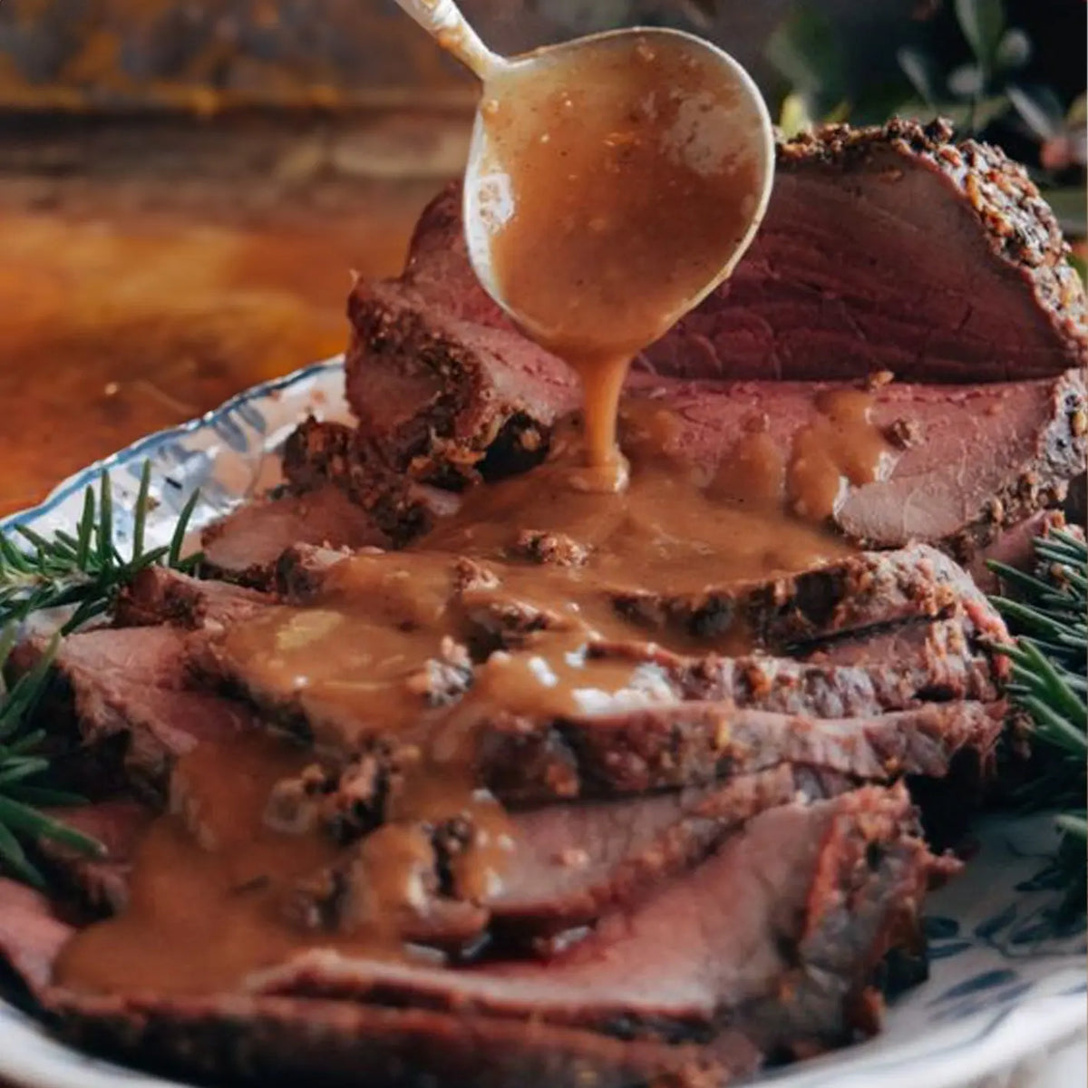 Sliced roast beef joint with gravy poured over – roast beef cooking times